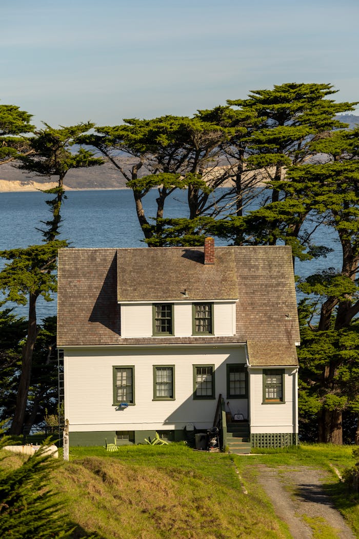 Charming white house by sea with scenic ocean view. Ideal nature and travel setting.